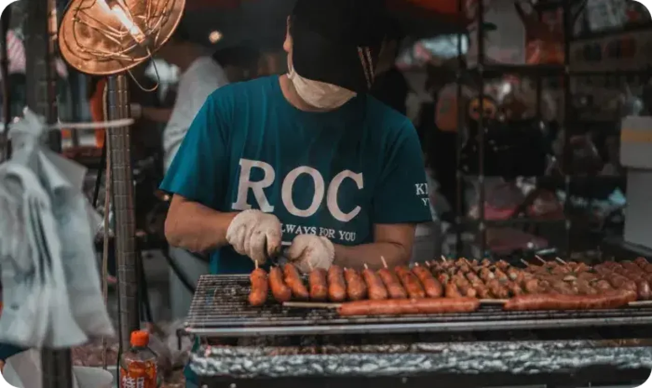 Man Grilling Sausages