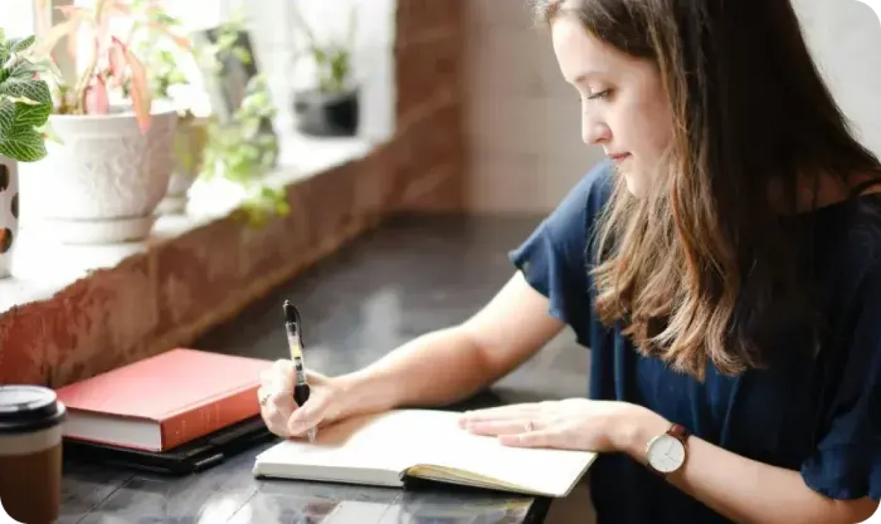 One woman writing in a notebook
