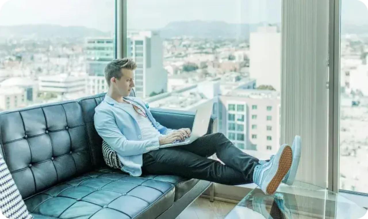 One man working on laptop by the window