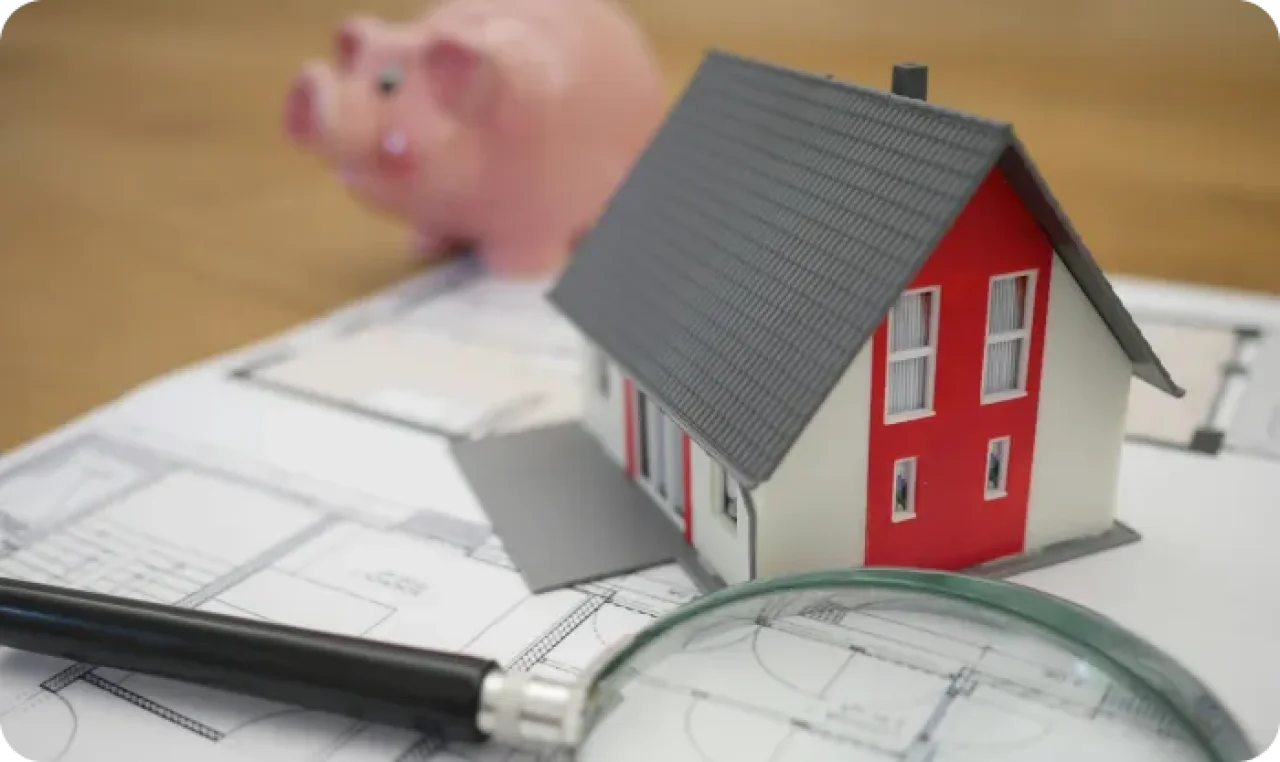 Real Estate Planning With House Model And Blueprints