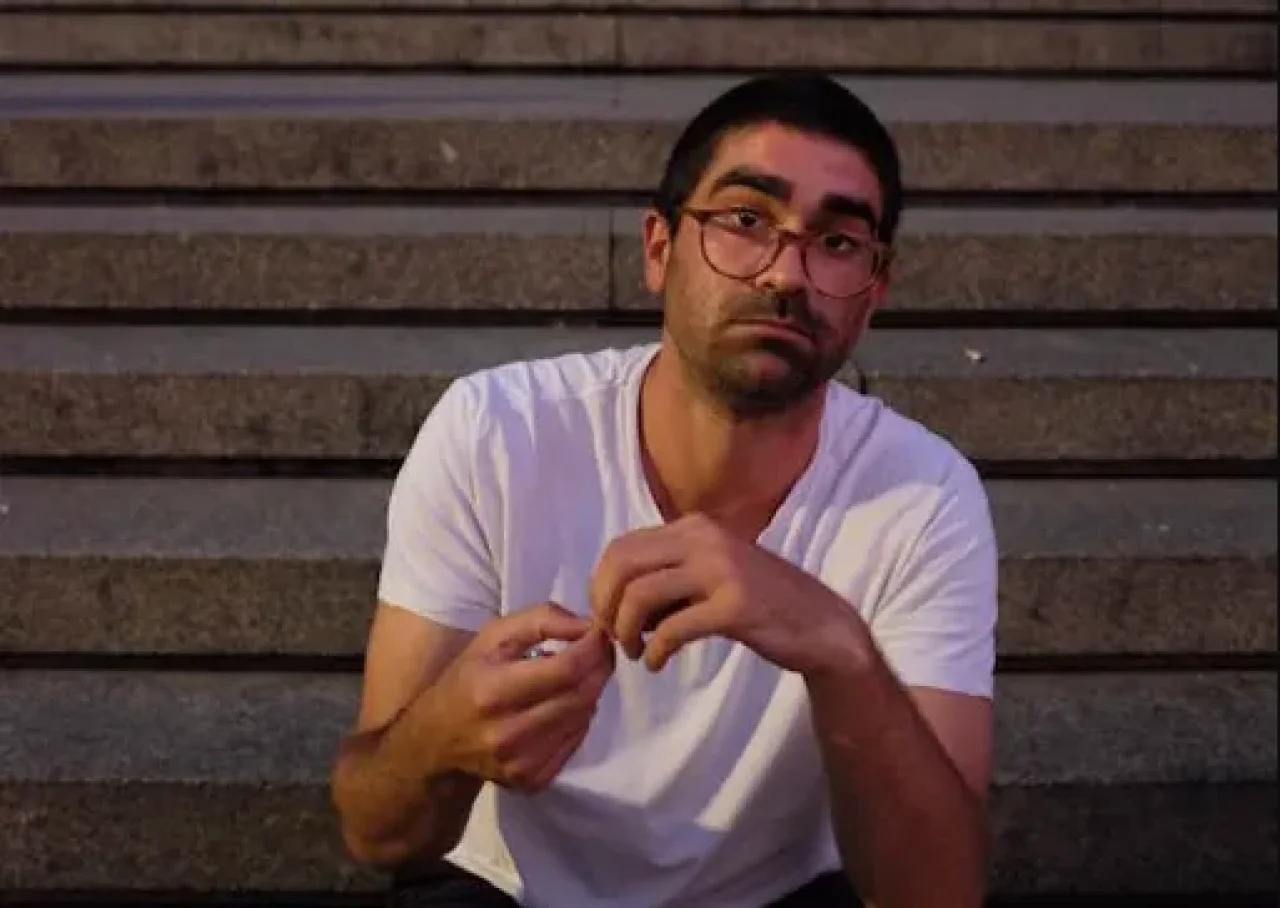 Brandon Topp, smiling, dressed in professional attire, with a softly lit background