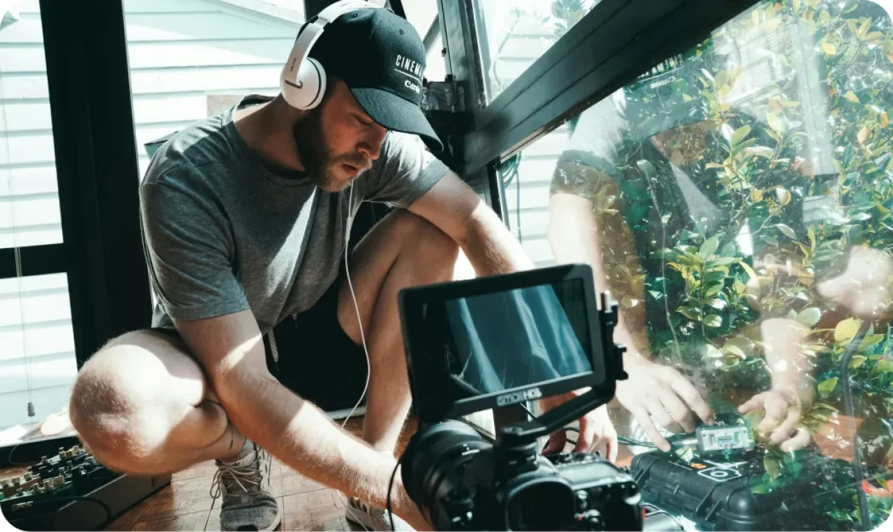 filmmaker-recording-audio-with-headphones-and-camera