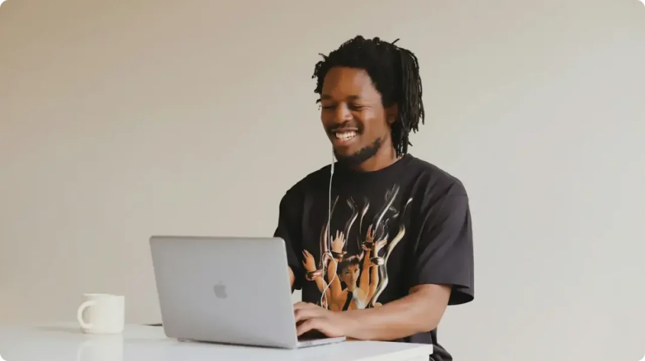 Man in black crew neck t shirt using macbook